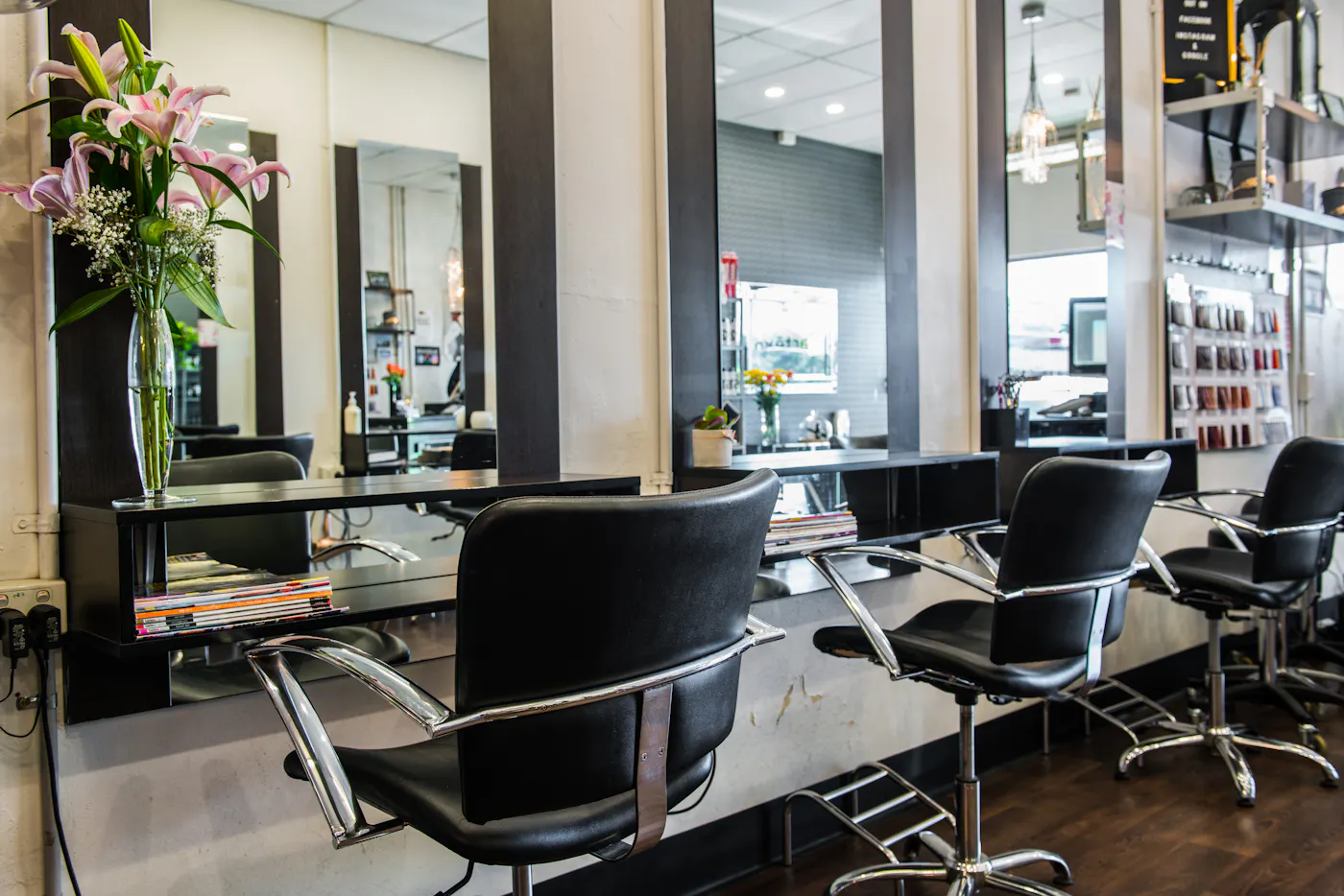 Black styling chairs and mirror stations inside InVogue